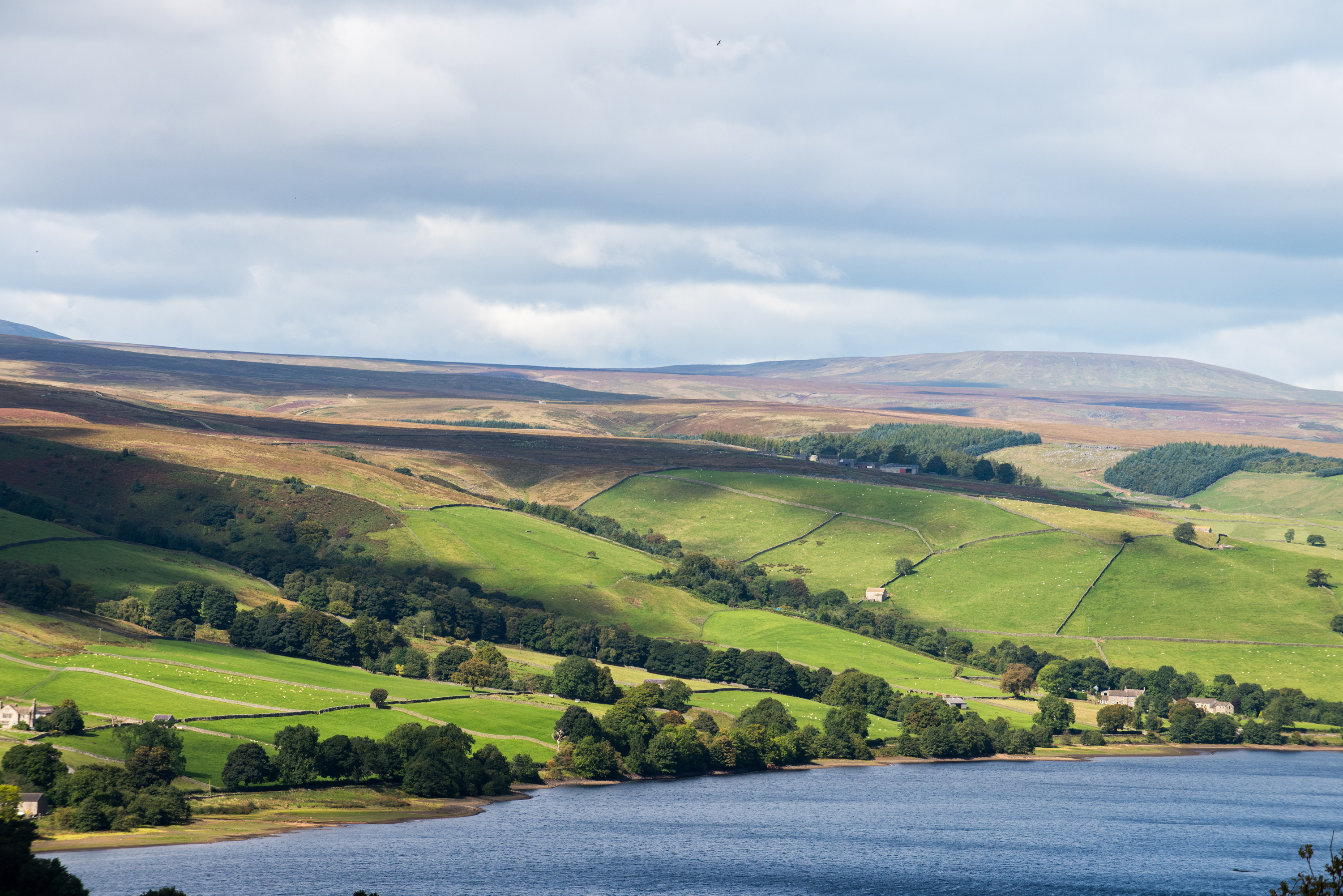 Landscape photograph of water with green hills behind